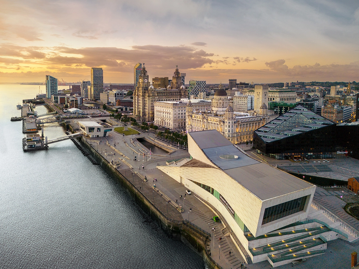 High-altitude aerial drone photograph of the Liverpool Museum and the Three Graces at the Pier Head waterfront, captured by DroneBiz.
